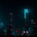 Shanghai skyline at night with neon lights illuminating the bustling business news scene.