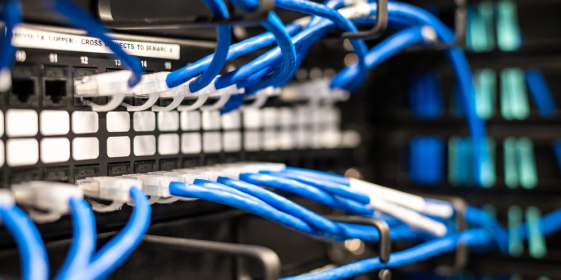 A rack of blue wires in a server room is showcased in business news.