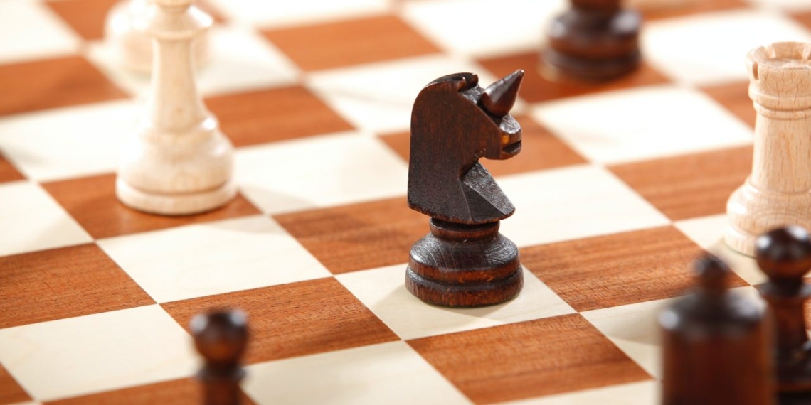 Business news about chess pieces on a chess board.