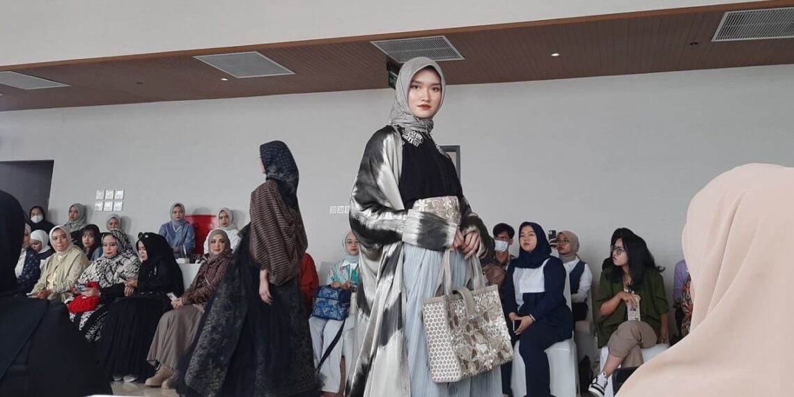 A model wears modest clothing made from Indonesian wastra at the kickoff of IN2MF 2023 in Jakarta (10/13).