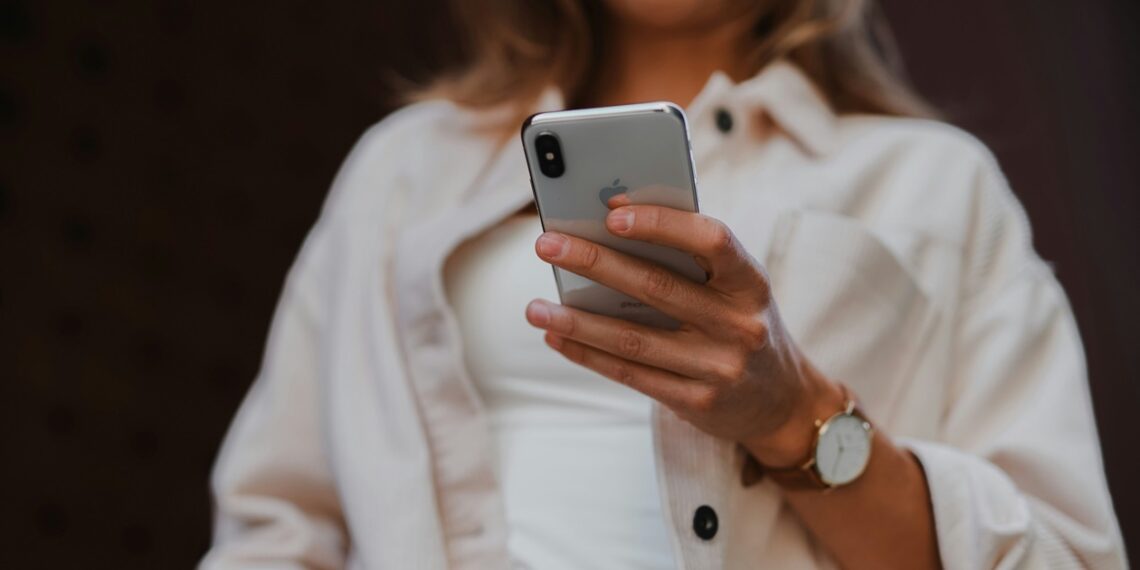 Illustration of an Apple smartphone user. Credit: Jenny Ueberberg/Unsplash
