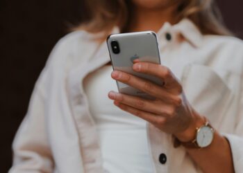 Illustration of an Apple smartphone user. Credit: Jenny Ueberberg/Unsplash