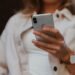 Illustration of an Apple smartphone user. Credit: Jenny Ueberberg/Unsplash